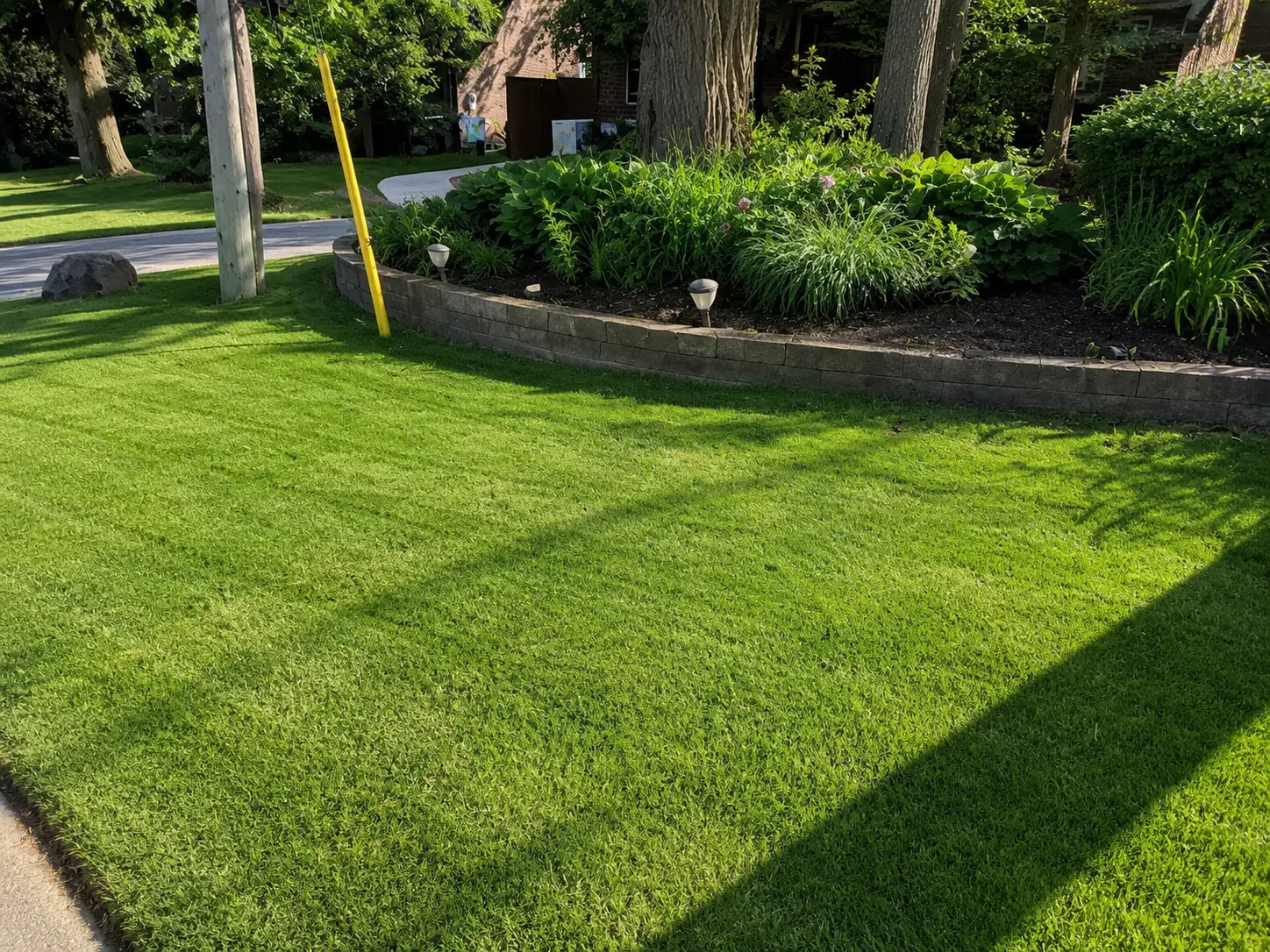 Front Lawn with Stone Retaining Wall Garden Bed